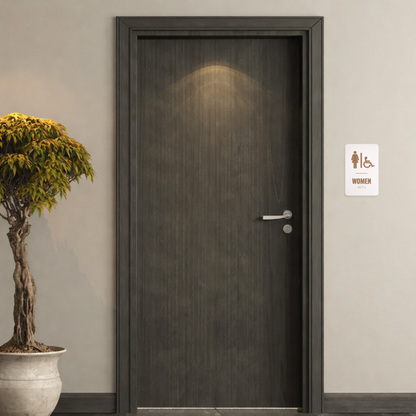 Dark wooden door with a women's restroom sign on a beige wall, next to a potted plant.
